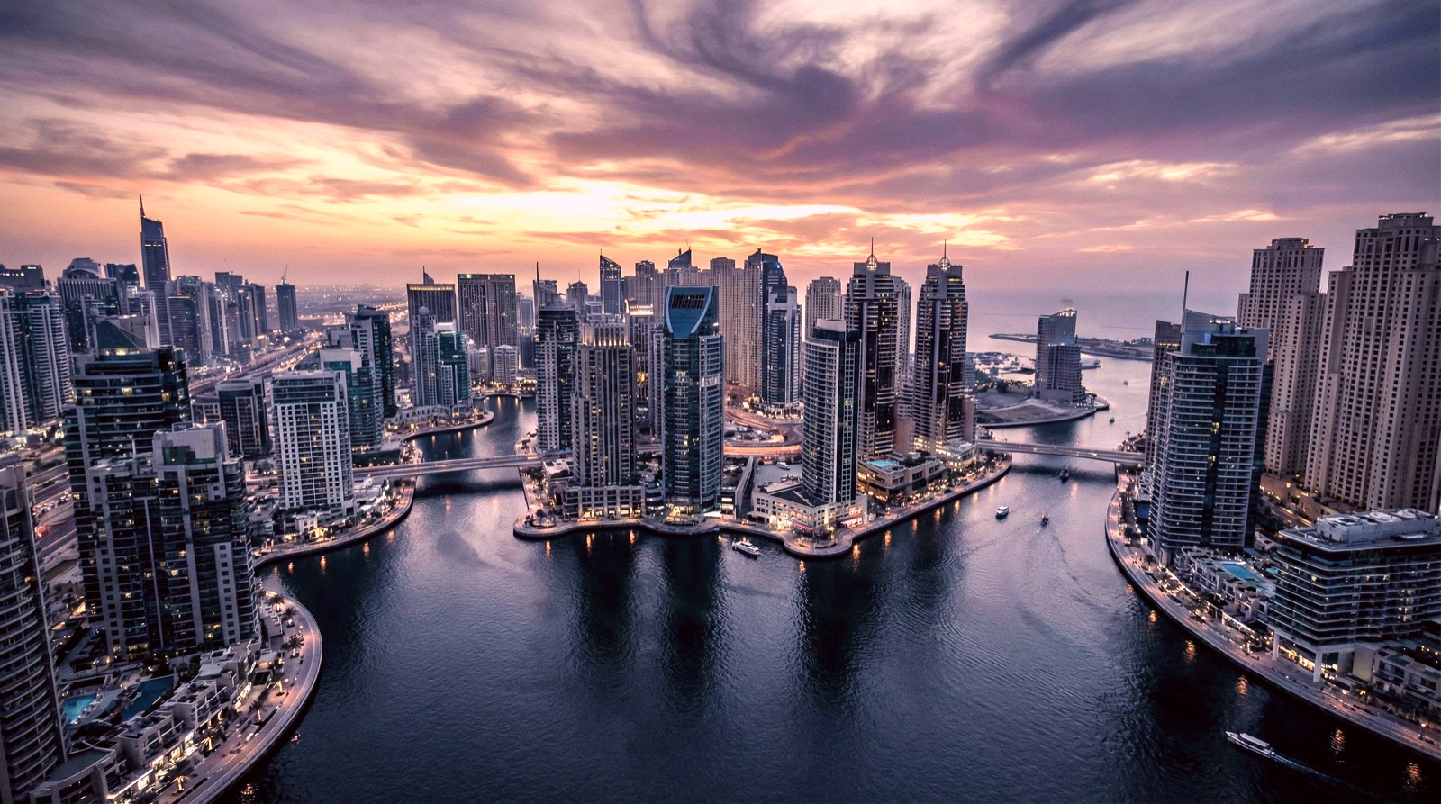 Aerial view of Dubai Marina skyline at dusk showing luxury residential towers amid uncertainty caused by Iran attacks on regional investor confidence in 2026.